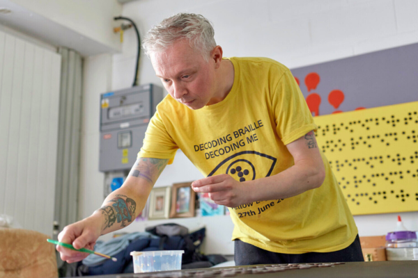 A photo of Clarke making artwork.